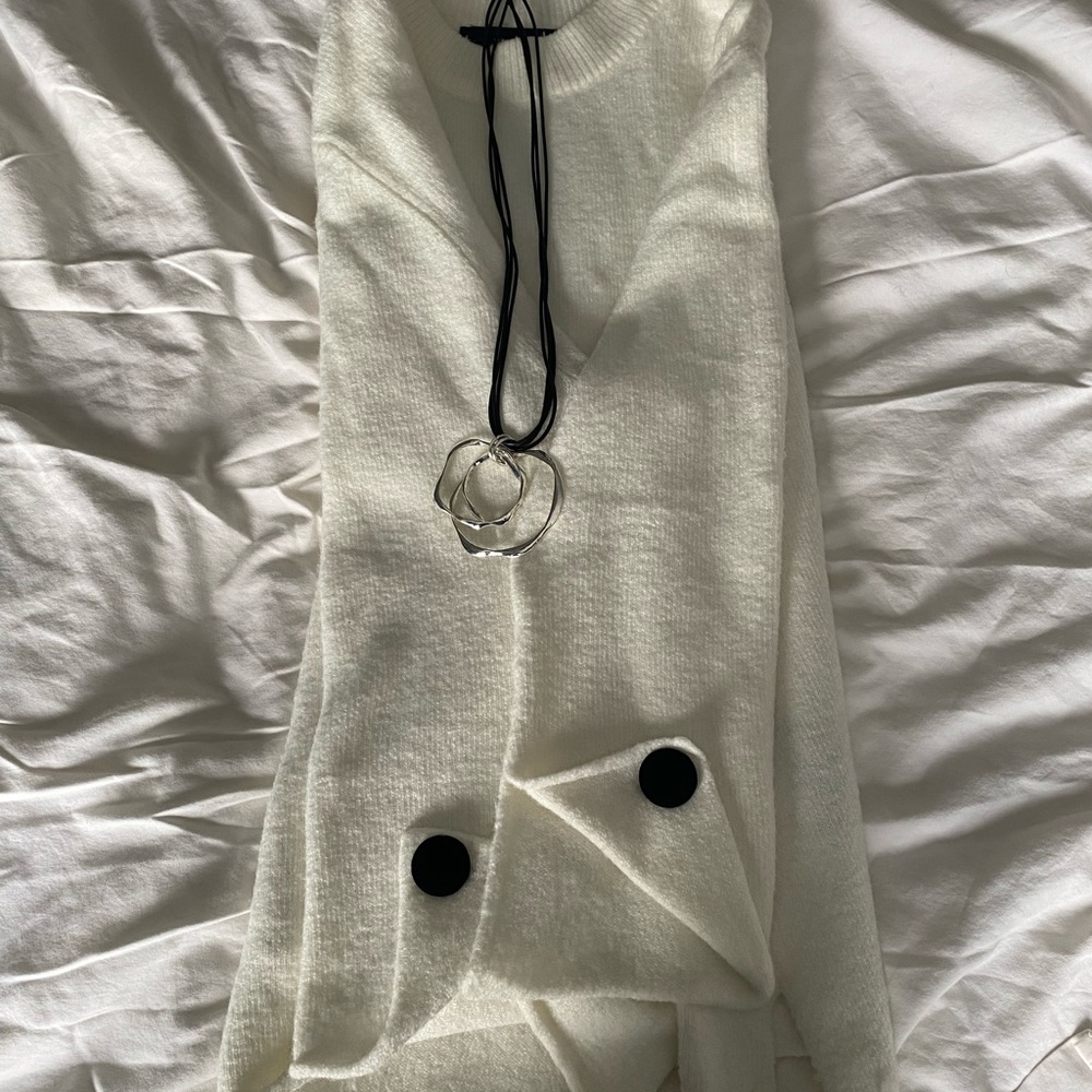 Oversized cream sweater with cuff accents